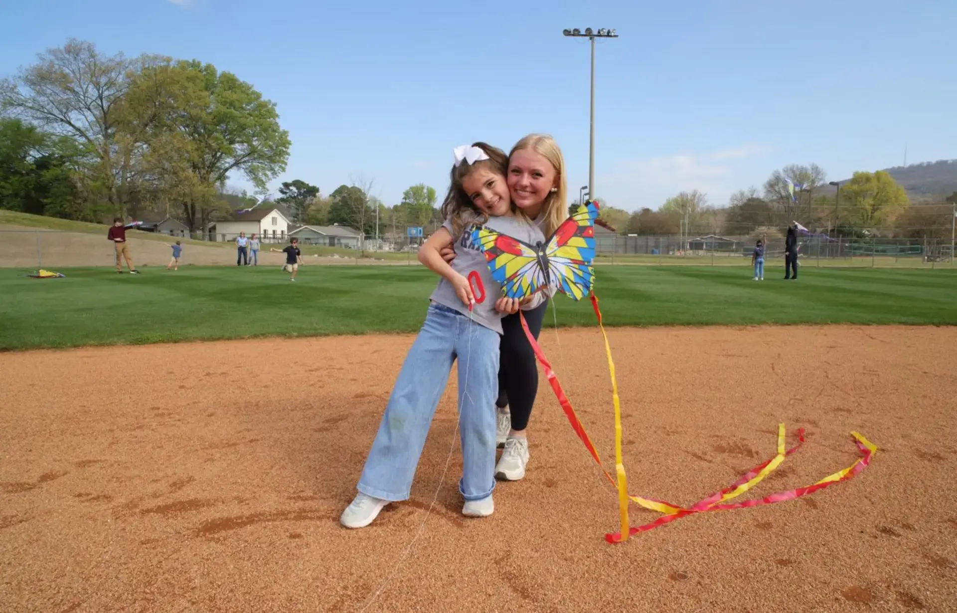 Students holding a kite
