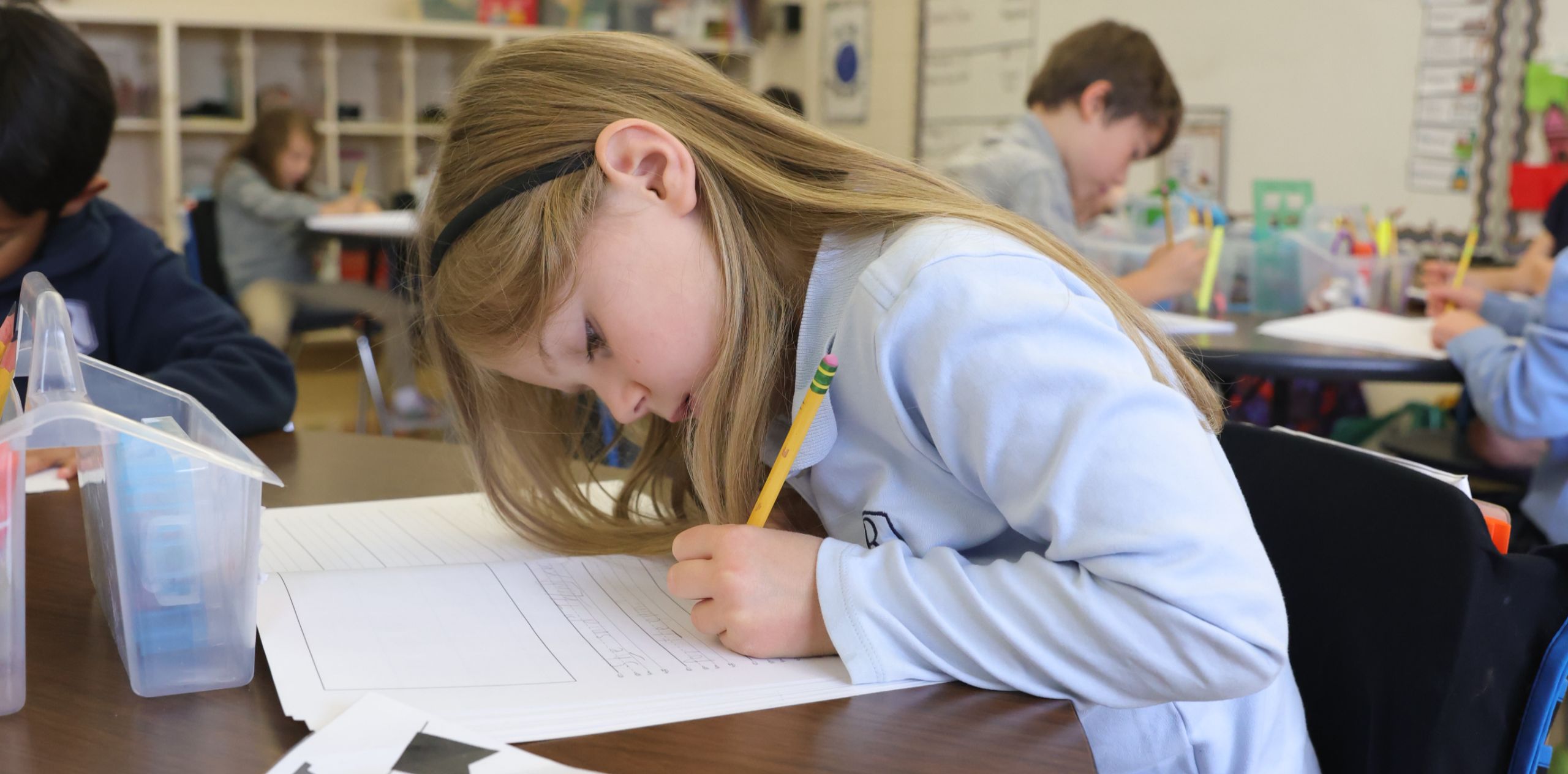 student writing on a paper