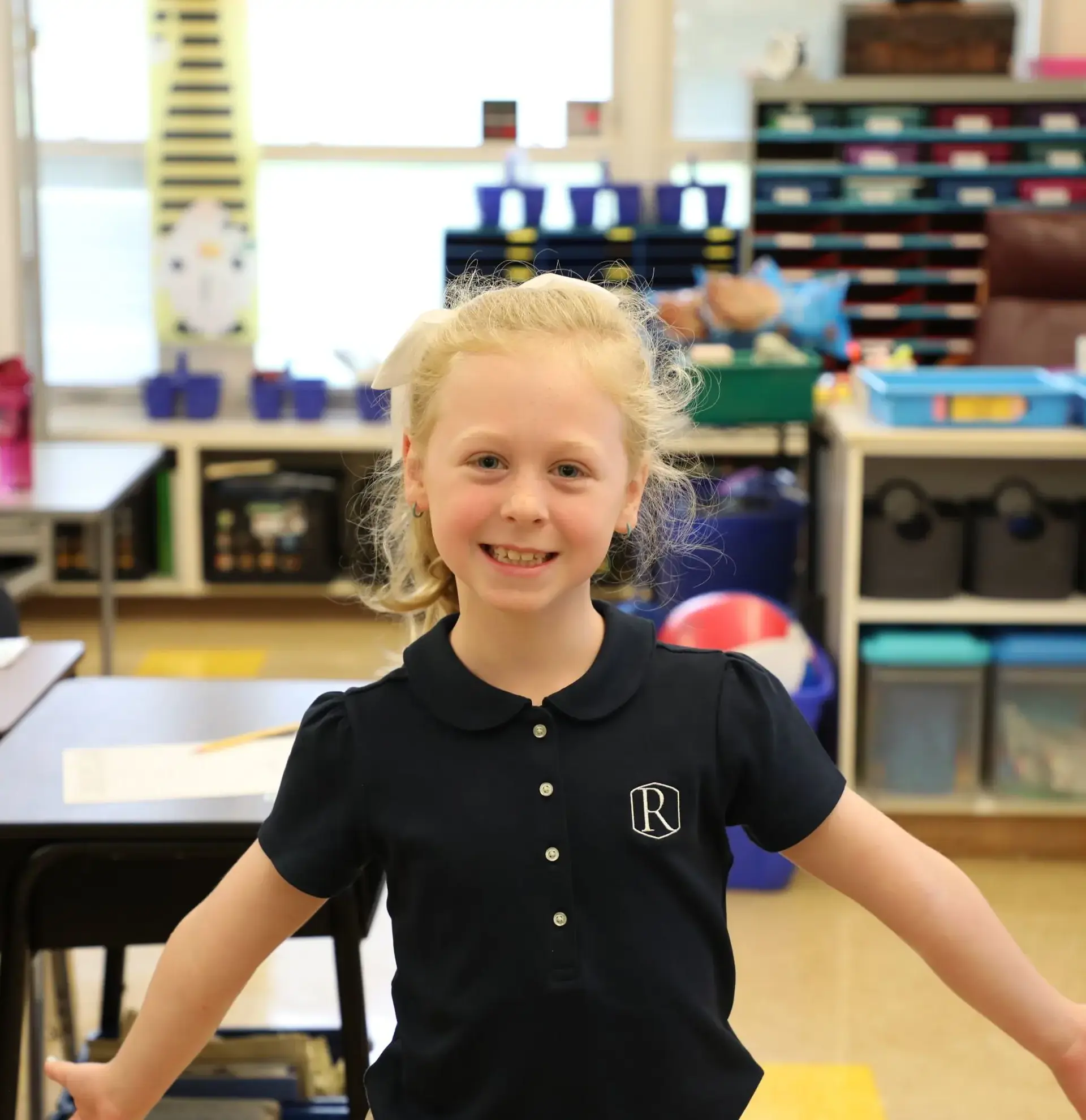 Randolph student stands proudly in her classroom. 