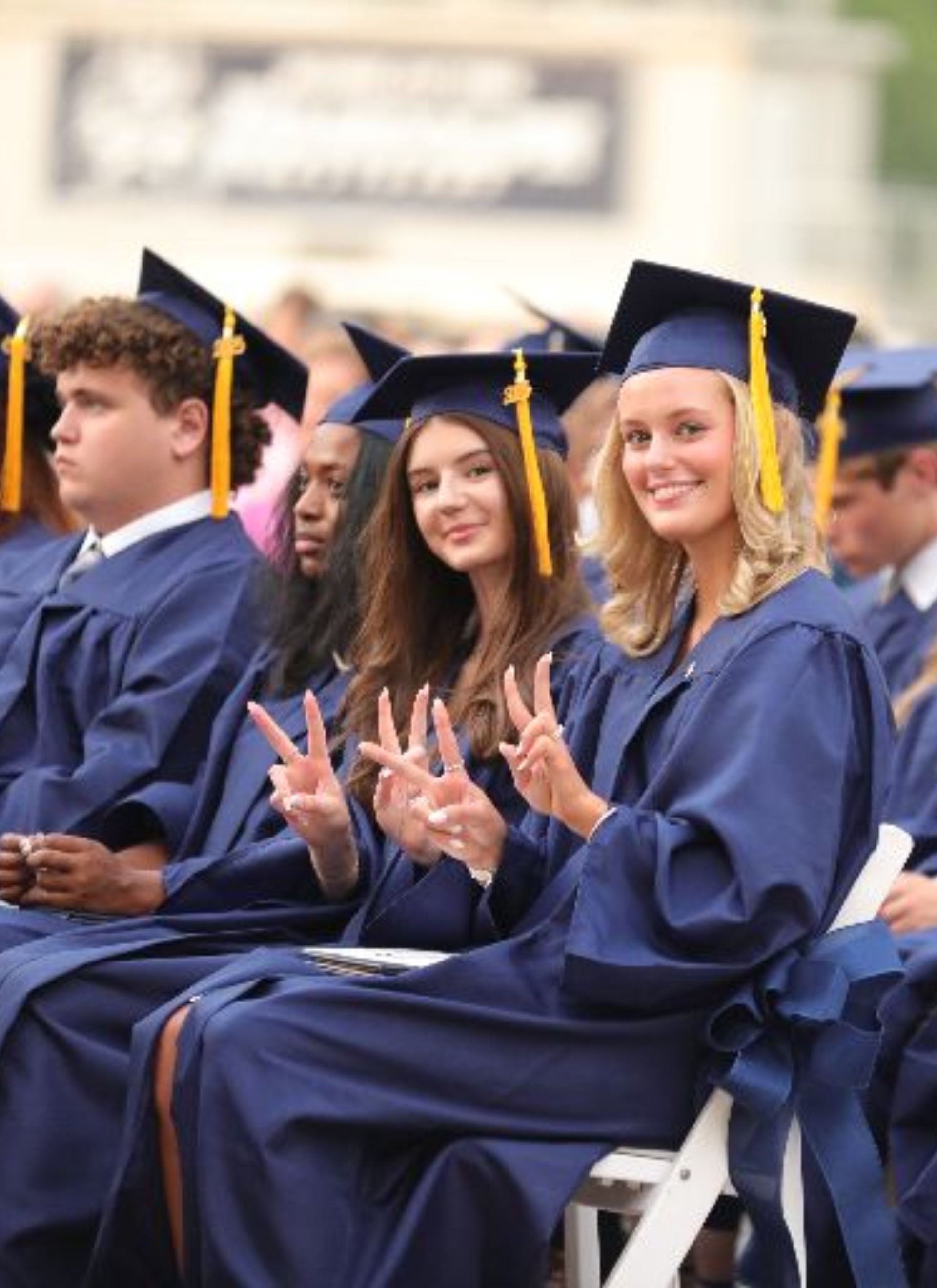 graduating students celebrating with a high five
