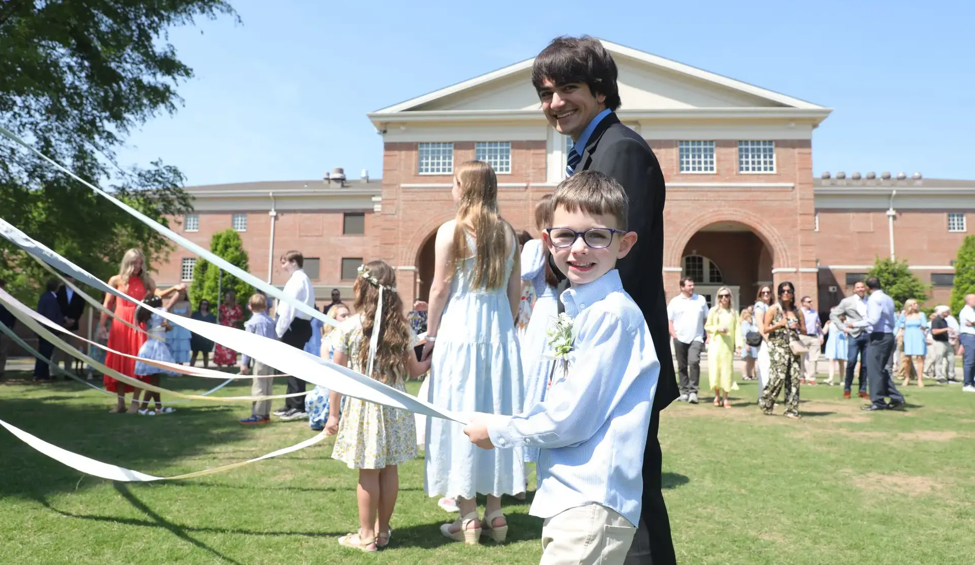 Seniors and their kindergarten buddies dance the maypole during Closing Convocation. 