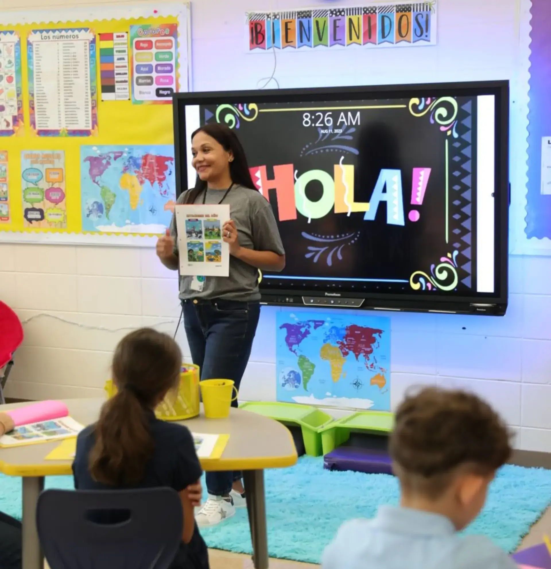 A Randolph School Spanish teacher works with lower school students, guiding them through a language lesson with interactive activities and engaged participation.