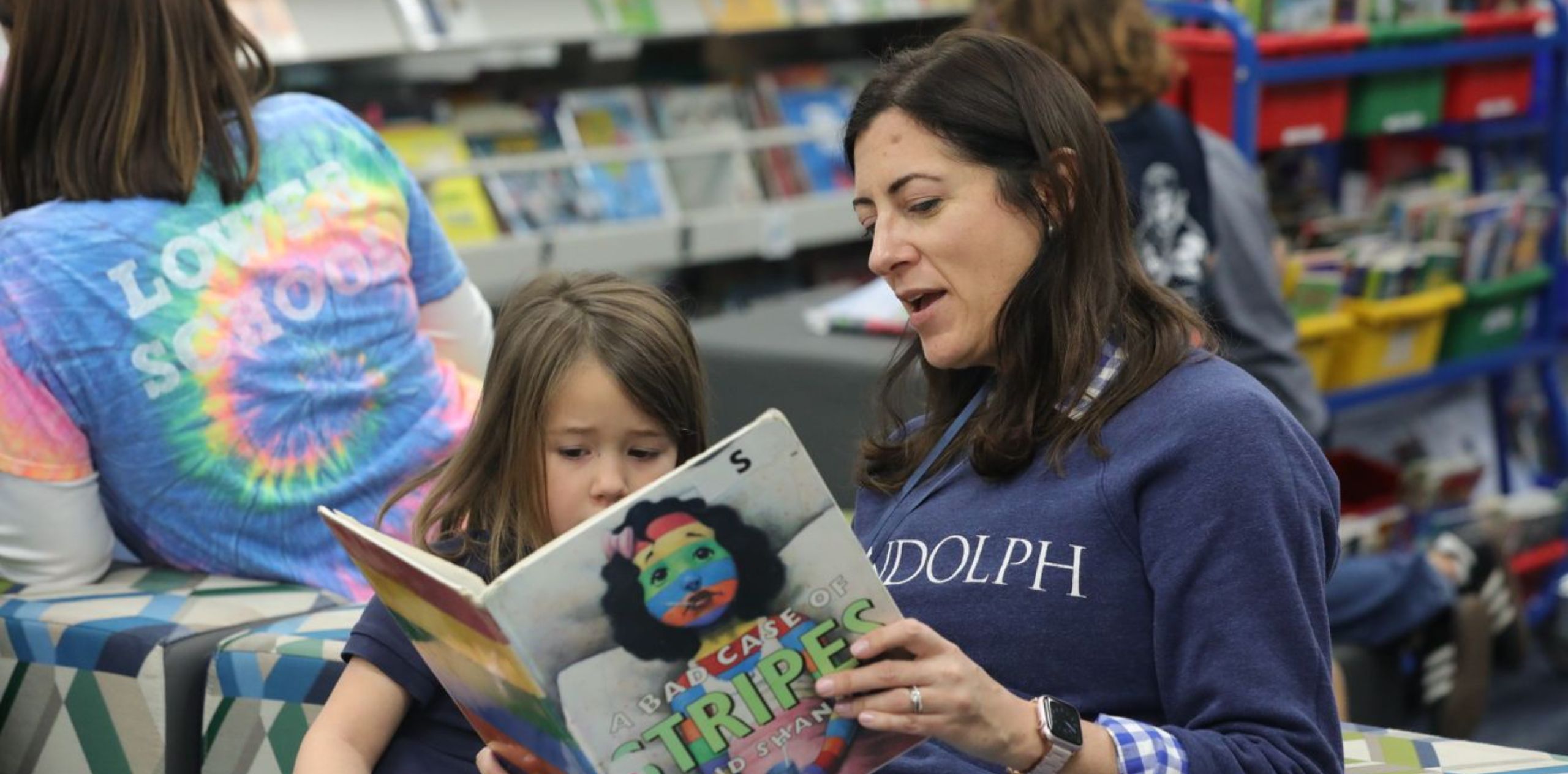 teacher and student reading together
