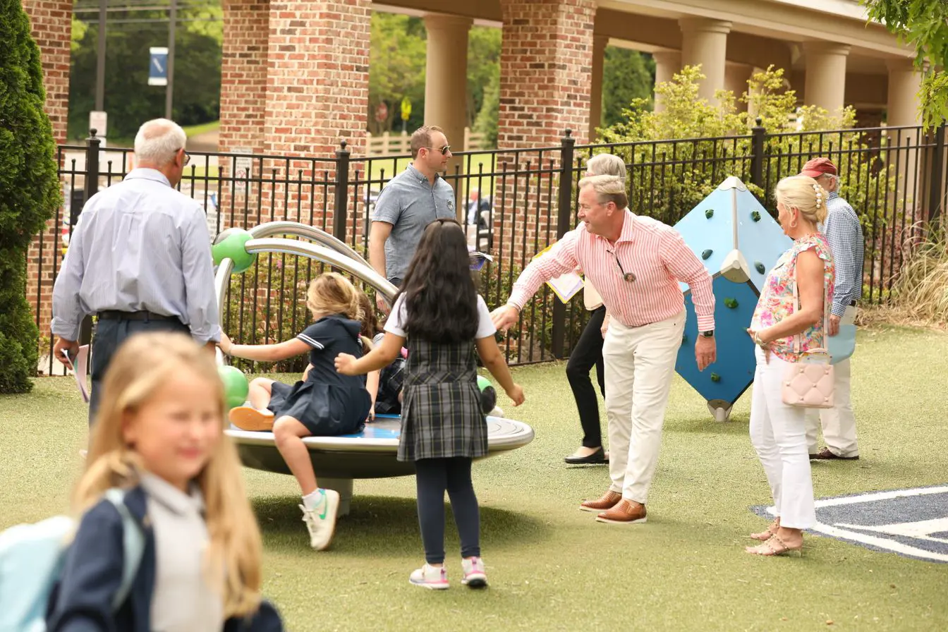 Parents playing with their children in the school's playground