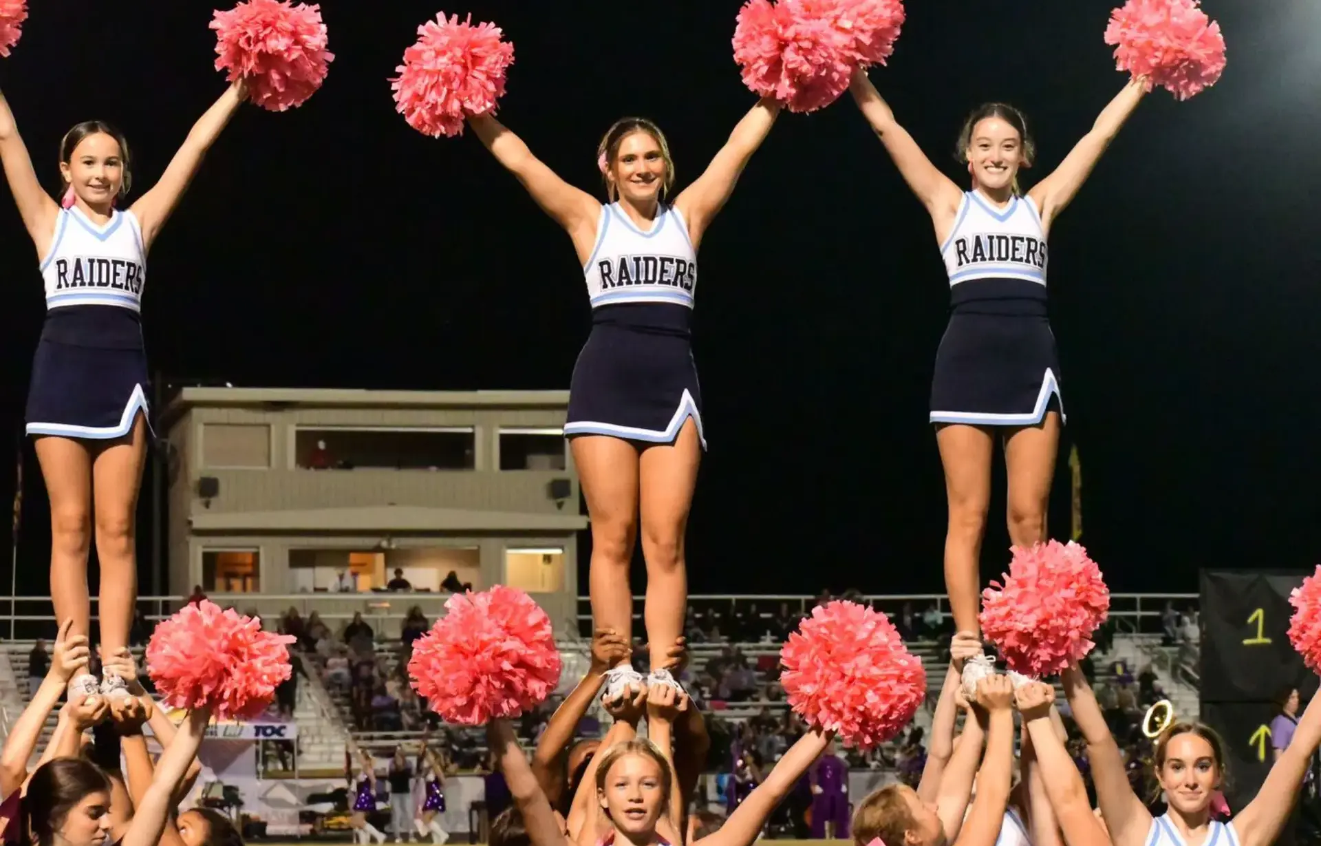 Cheerleading team performing a stunt