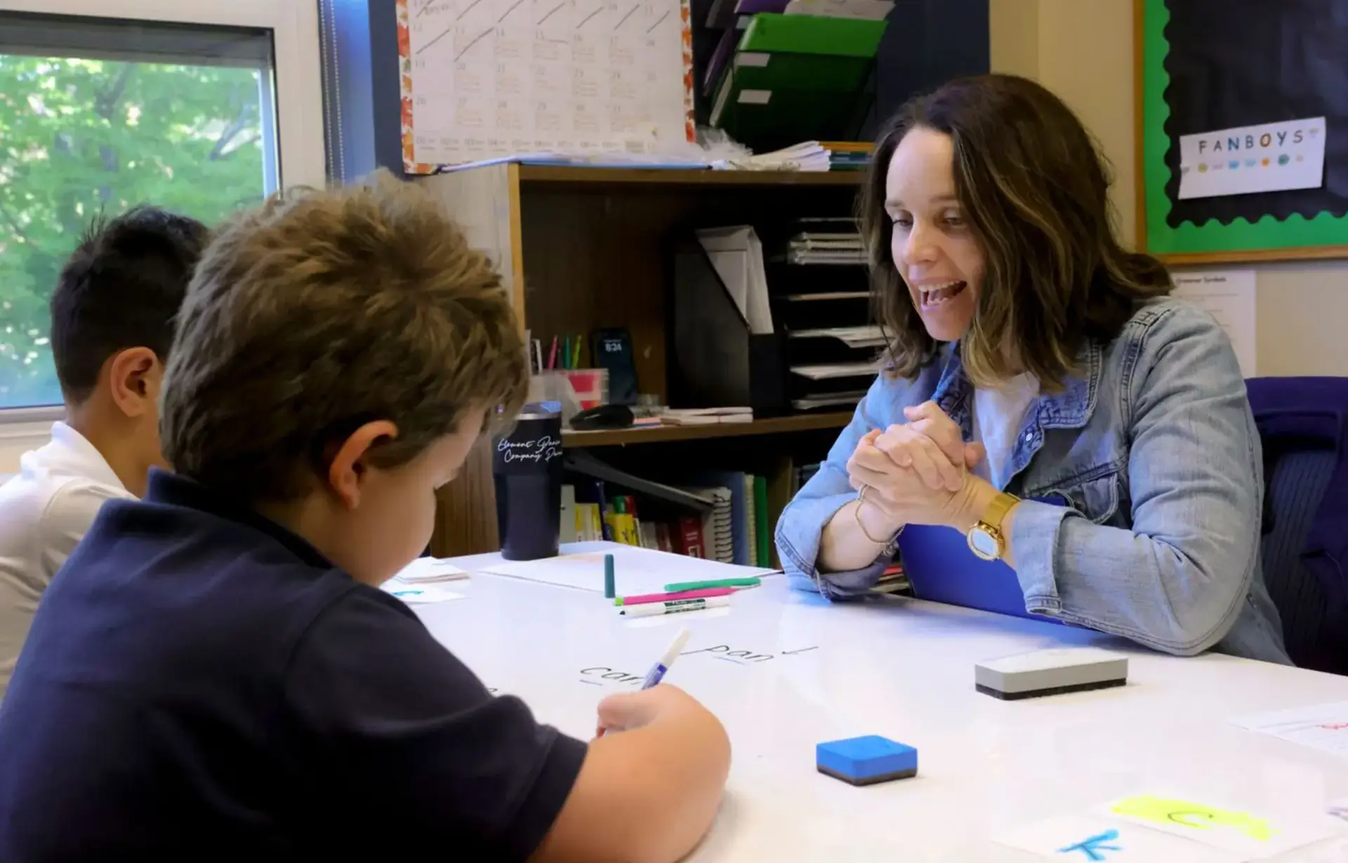 Student working one-on-one with a teacher in a dyslexia-focused lesson.