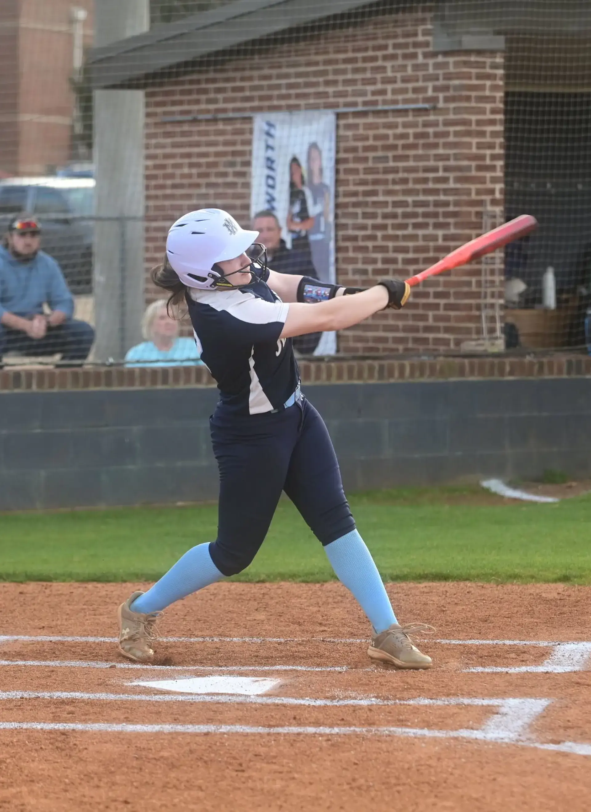 Students hitting a ball on a baseball game