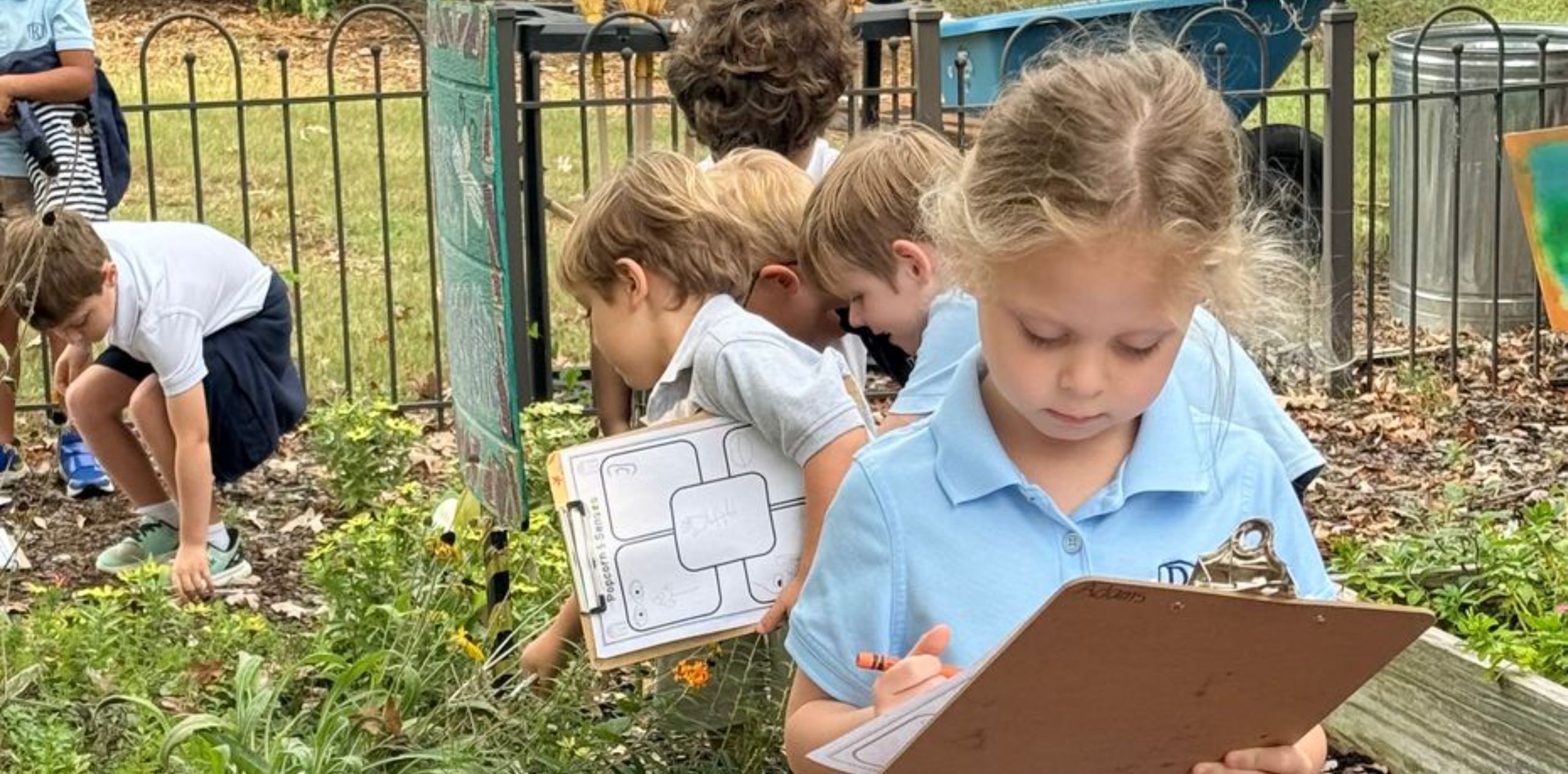 students writing on a clipboard