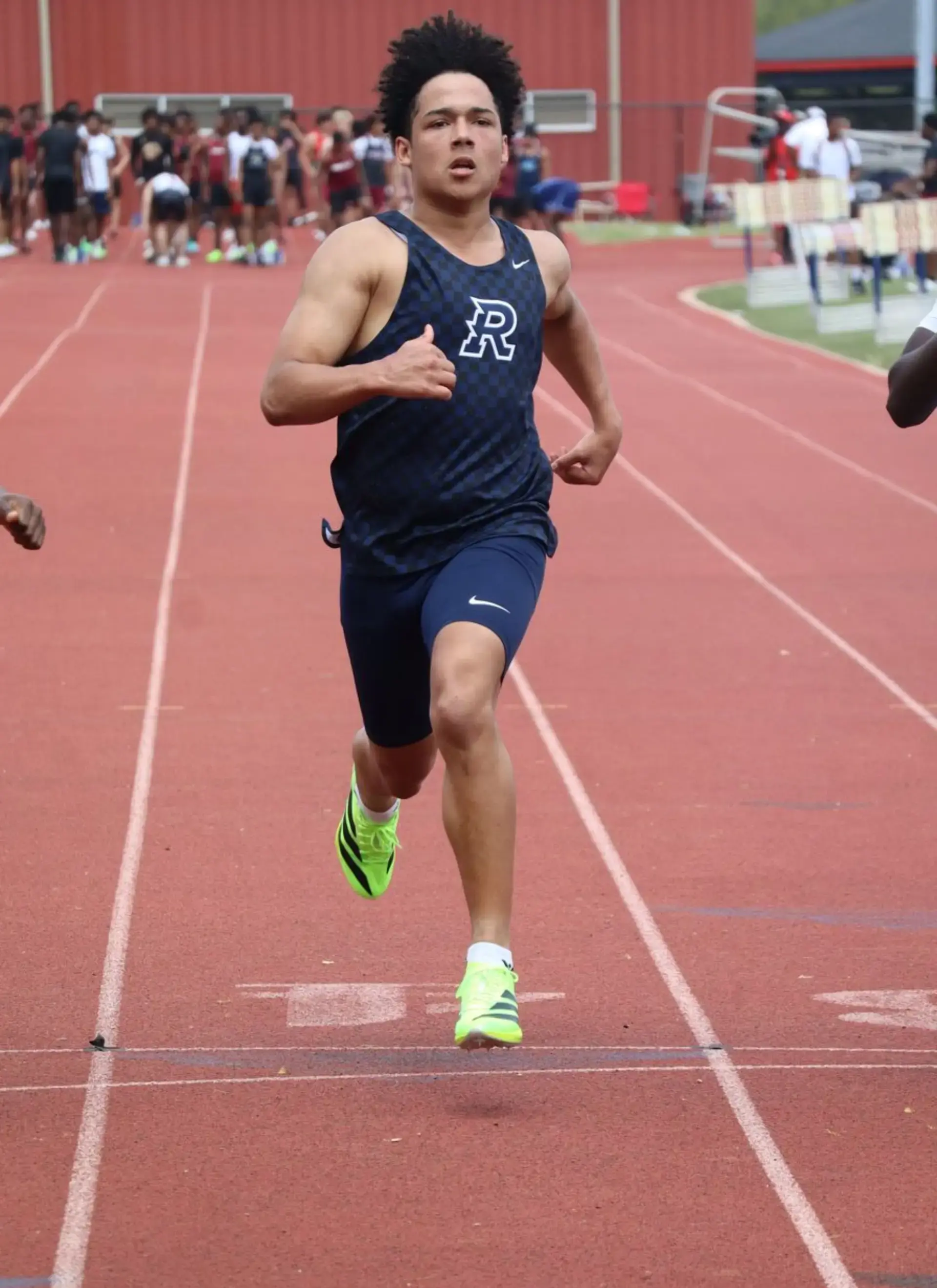 Track athlete sprinting down the track during a race.