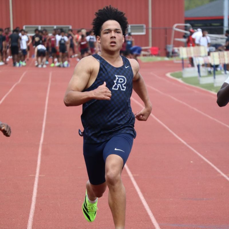 Student sprinting down the track during a race.