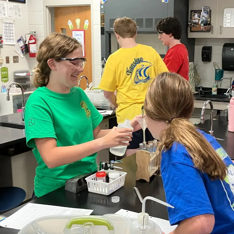 Middle School girls learning in the chemistry lab.