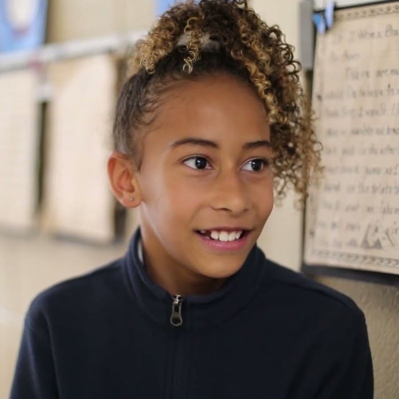Smiling student in a school uniform